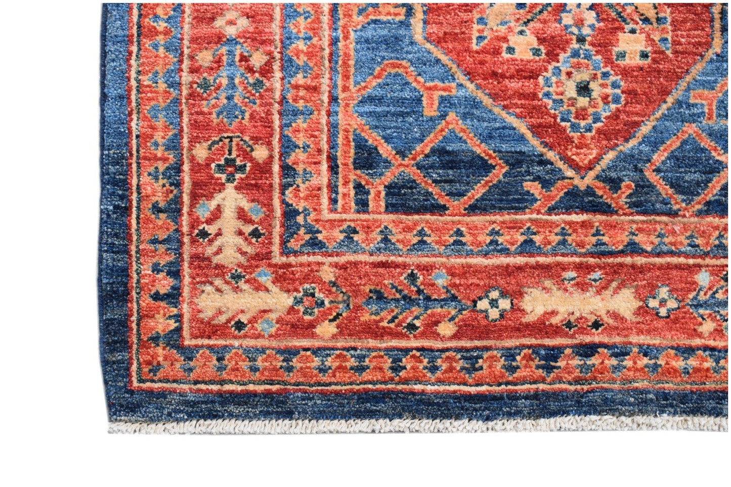 Handmade Afghan Chobi runner featuring a traditional geometric pattern in red and blue wool.