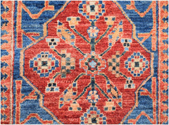 An Afghan Chobi runner featuring a traditional red diamond medallion pattern on a blue background.