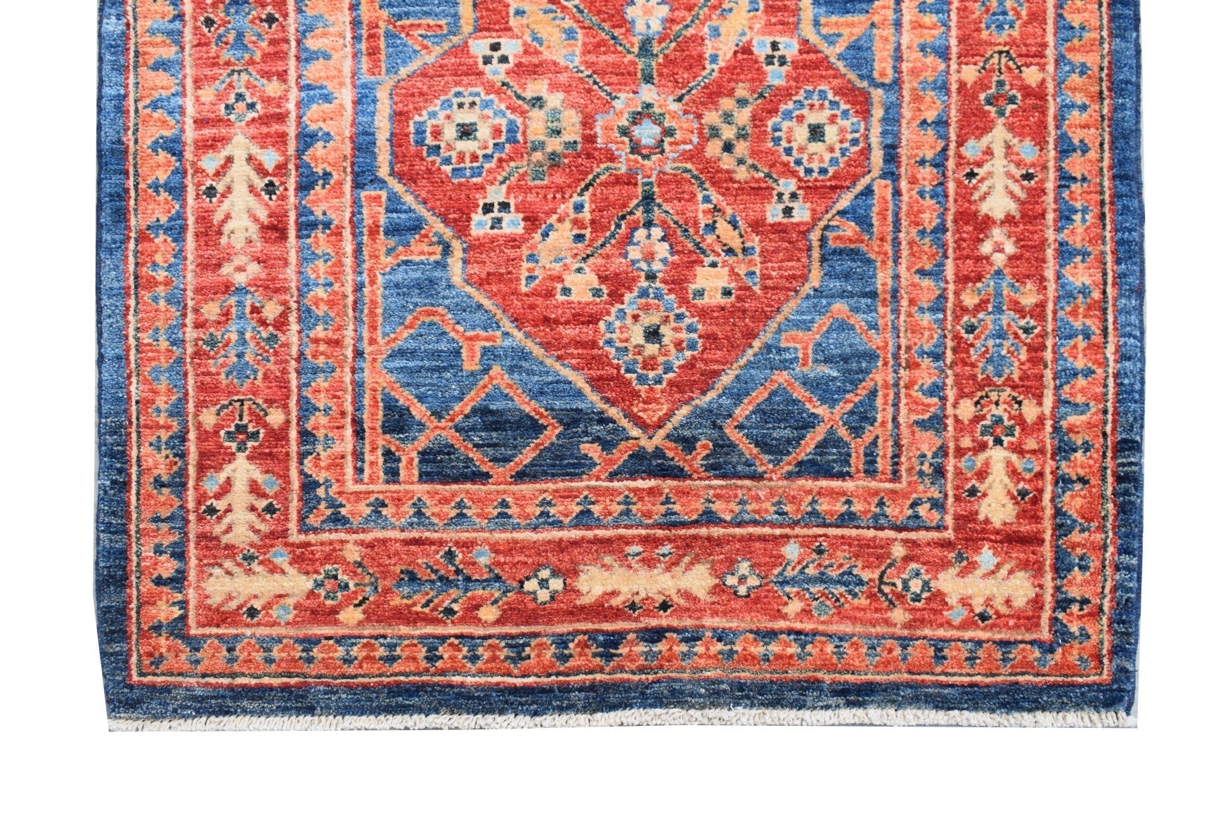 Handmade Afghan Chobi runner rug featuring a traditional geometric pattern in red and blue.