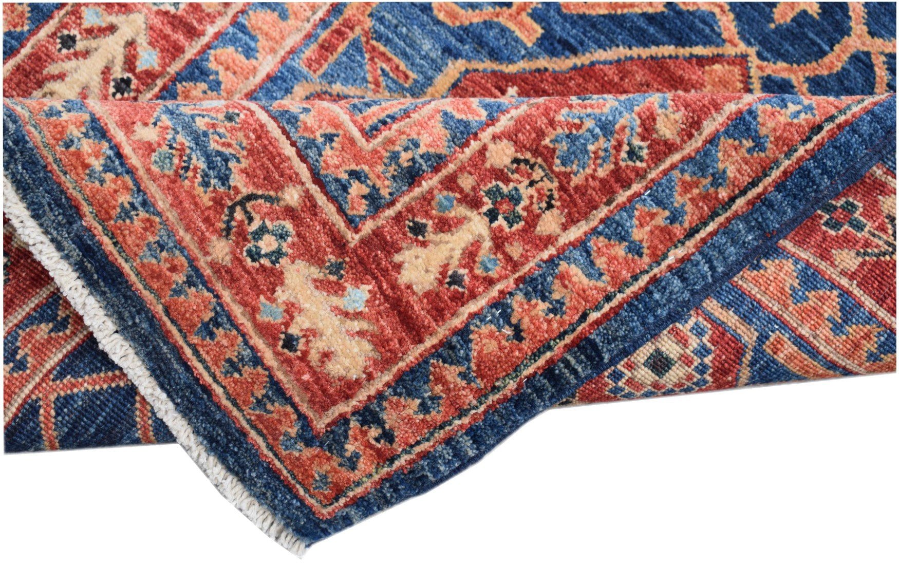 A folded Afghan Chobi runner featuring a traditional floral pattern in red, blue, and beige.