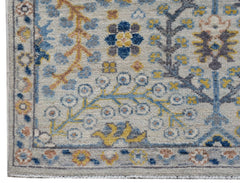 A handmade Afghan Chobi runner featuring a traditional floral pattern in blue, yellow, and grey.