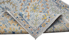 A hand-knotted Afghan Chobi runner featuring a traditional floral pattern in blue, yellow, and tan.