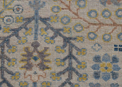 A close-up of an Afghan Chobi runner featuring intricate floral patterns in blue and yellow wool.