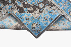 An Afghan Chobi runner featuring a traditional floral pattern in blue, grey, and brown wool.