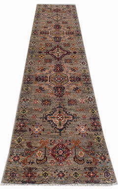 A handwoven Afghan Chobi runner rug featuring traditional geometric patterns in earthy tones.