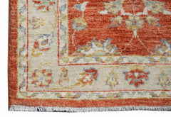 A handwoven Afghan Chobi runner featuring a traditional floral pattern in rust and cream tones.