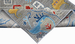 A handwoven Afghan Chobi runner featuring a grey background with colorful traditional motifs.