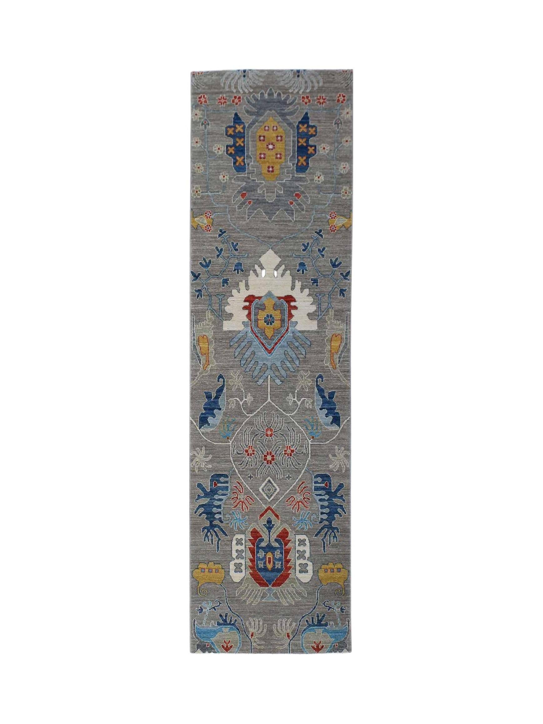 An Afghan Chobi runner rug featuring traditional floral motifs in blue, red, and yellow on grey.