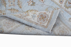 A handwoven Afghan Chobi runner featuring a light blue field with traditional floral patterns.