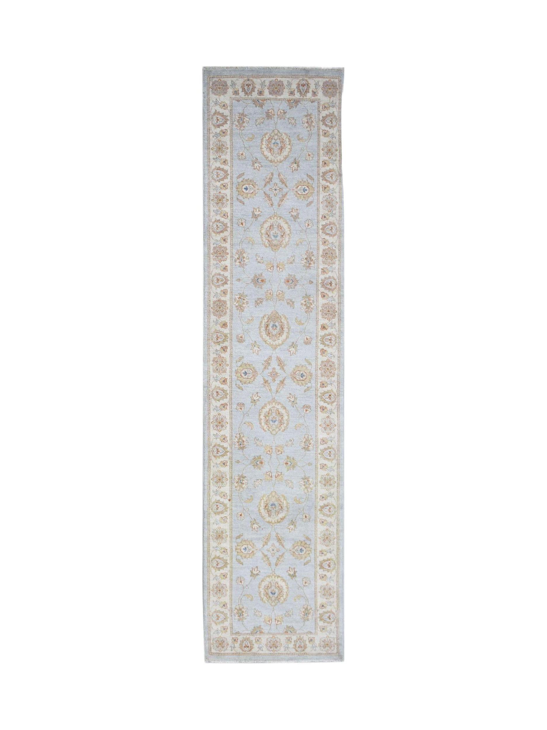 A handmade Afghan Chobi runner rug featuring a traditional floral pattern in soft blue and beige.