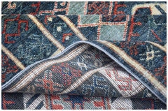 A close-up view of a handwoven Afghan Chobi runner featuring a geometric pattern in blue and red.