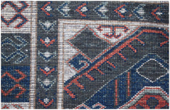A close-up of a handwoven Afghan Chobi runner featuring intricate geometric patterns in wool.