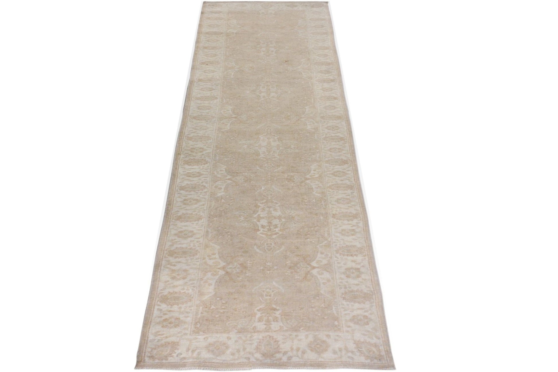 A handmade Afghan Chobi runner rug featuring a traditional beige and cream floral pattern.