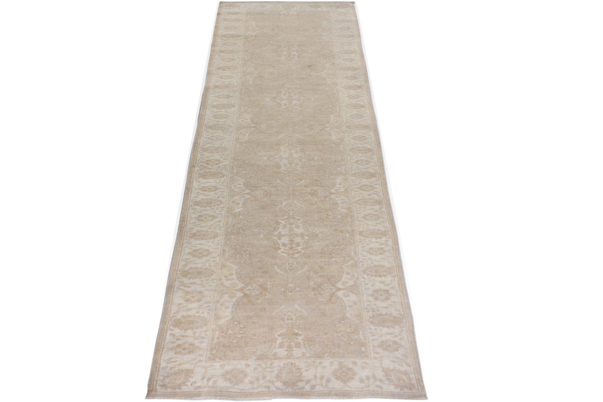 A handmade Afghan Chobi runner rug featuring a traditional beige and cream floral pattern.