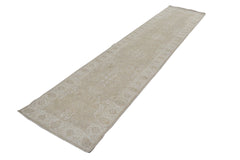 An Afghan Chobi runner rug featuring a traditional beige and cream floral pattern.