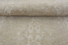 A close-up of a handmade Afghan Chobi runner featuring a subtle, light beige floral pattern.