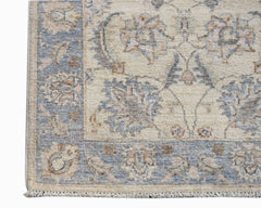A handwoven Afghan Chobi runner featuring a traditional floral pattern in soft blue and beige tones.