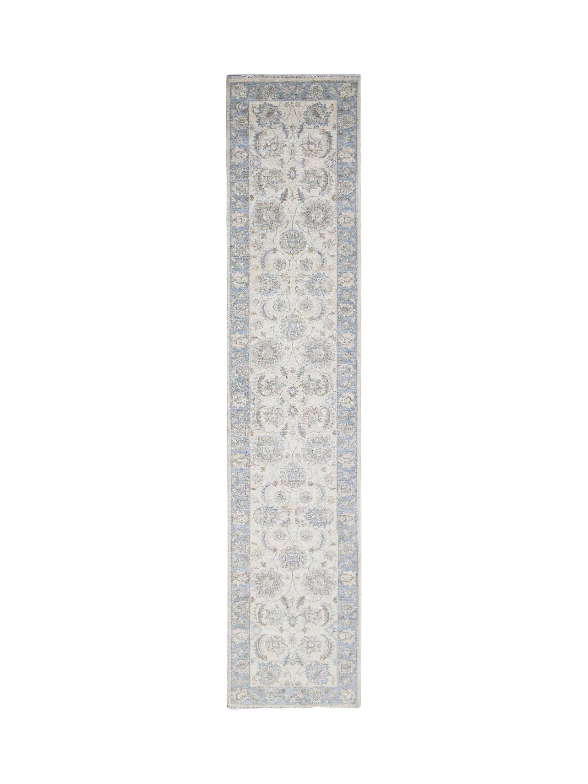 An Afghan Chobi runner rug featuring a traditional floral pattern in soft blue and beige tones.