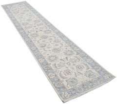 An Afghan Chobi runner rug featuring a traditional floral pattern in soft blue and cream tones.