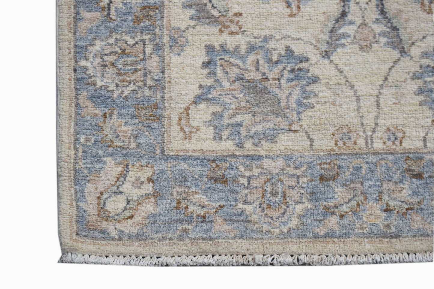 A handwoven Afghan Chobi runner featuring a traditional floral pattern in blue and beige tones.