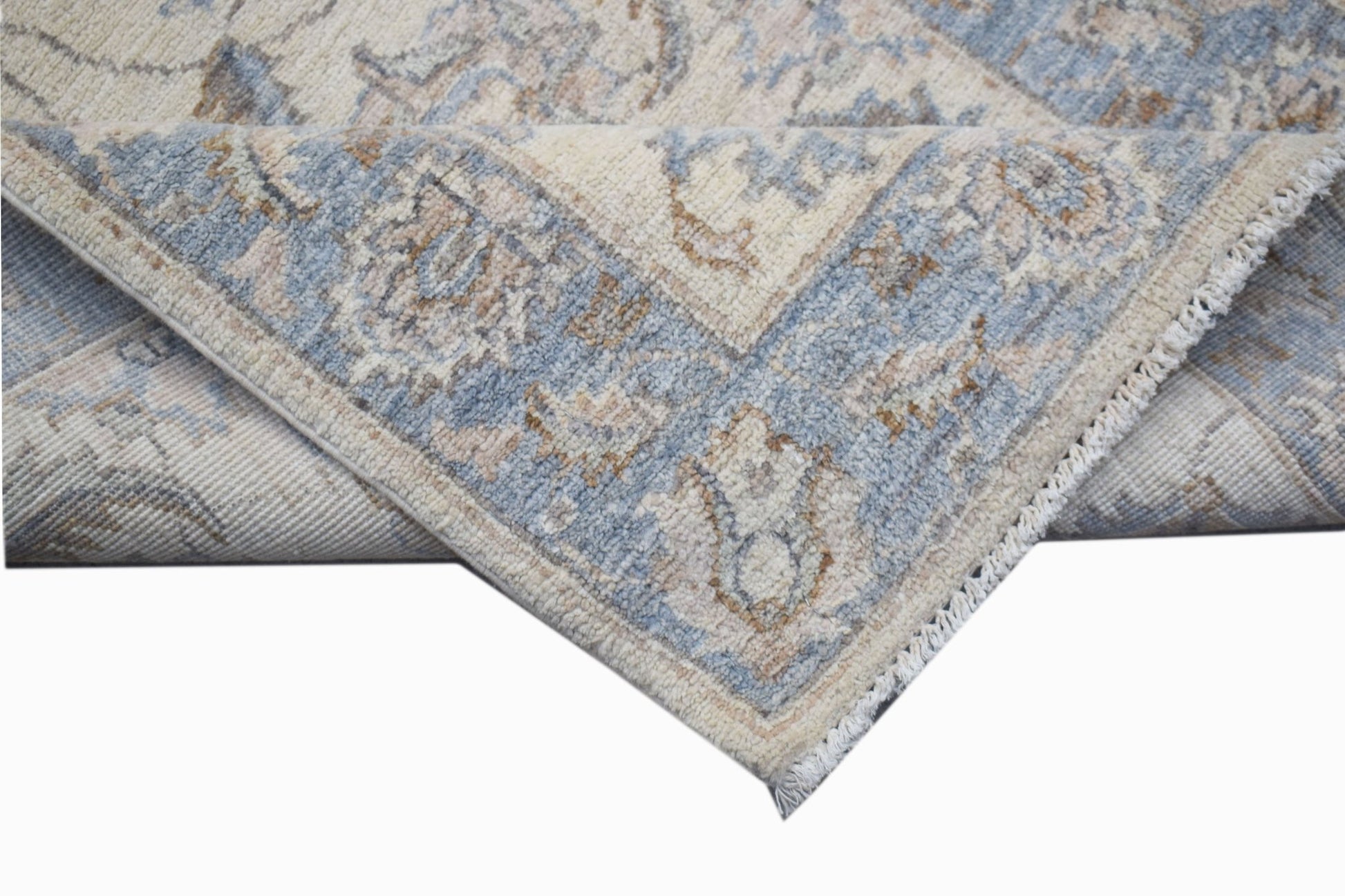 A handwoven Afghan Chobi runner featuring a traditional floral pattern in blue and beige tones.