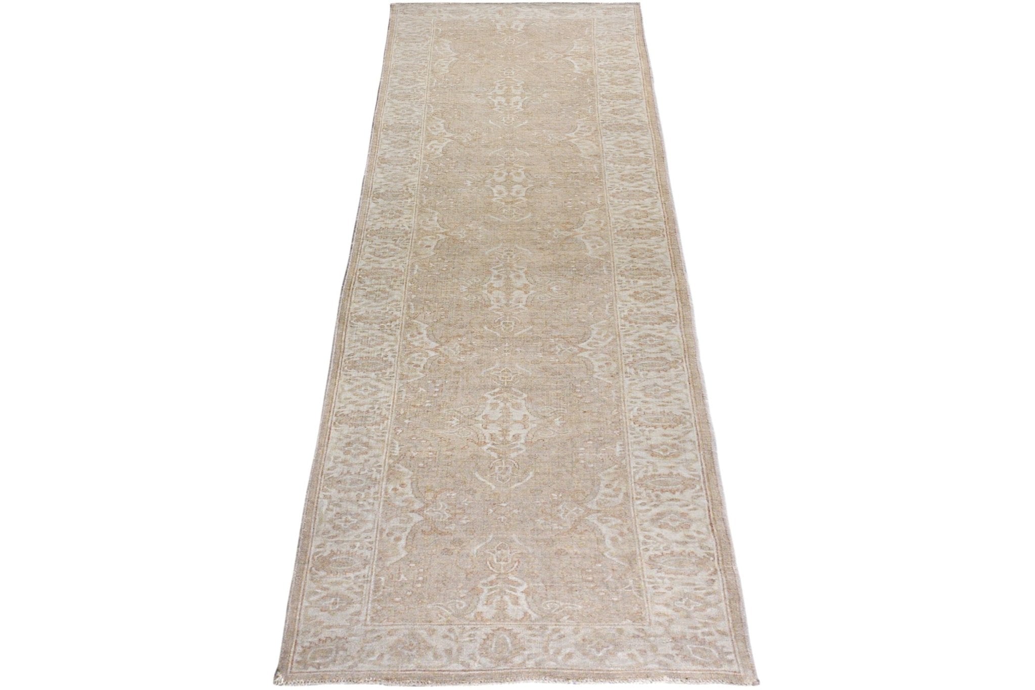 An Afghan Chobi runner rug featuring a traditional beige and cream floral pattern.