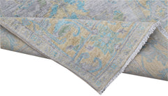 A handwoven transitional Oushak runner featuring a floral pattern in blue, grey, and beige tones.