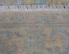 A close-up of a handwoven transitional Oushak runner featuring a floral pattern in muted tones.