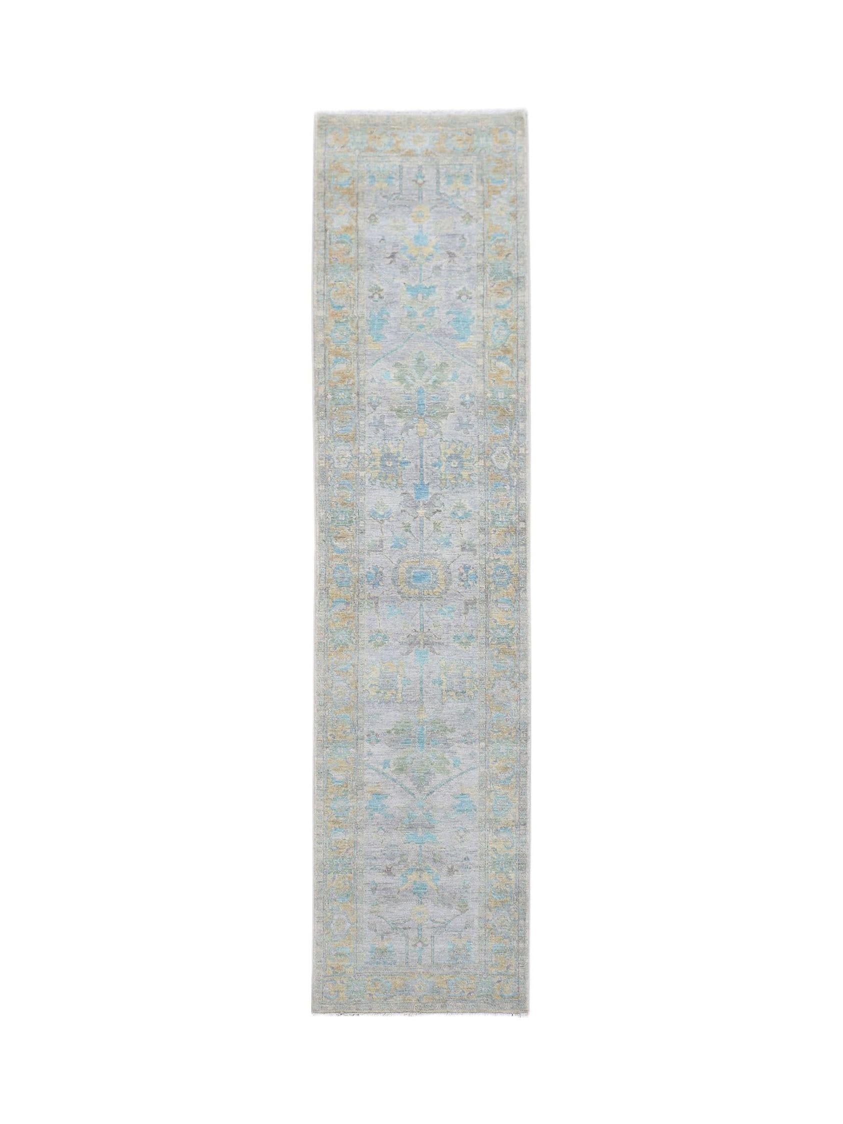 A handwoven transitional Oushak runner rug featuring a floral pattern in blue, yellow, and grey.