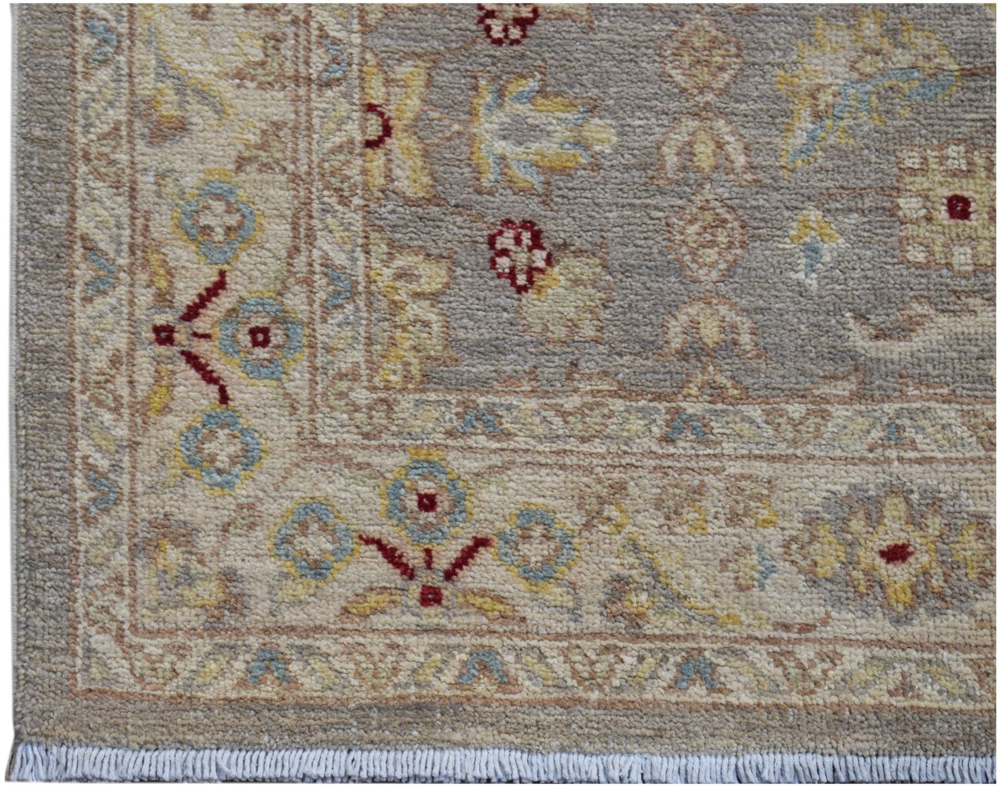 A hand-knotted Afghan Chobi runner featuring a traditional floral pattern in soft earthy tones.