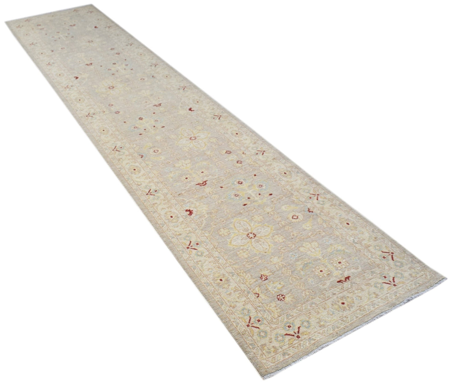 An Afghan Chobi runner rug featuring a traditional floral pattern in soft beige and muted tones.