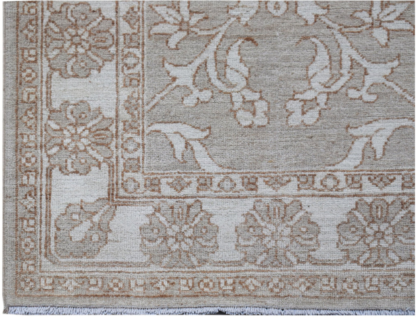 A hand-knotted Afghan Chobi runner featuring a traditional floral pattern in beige and cream tones.