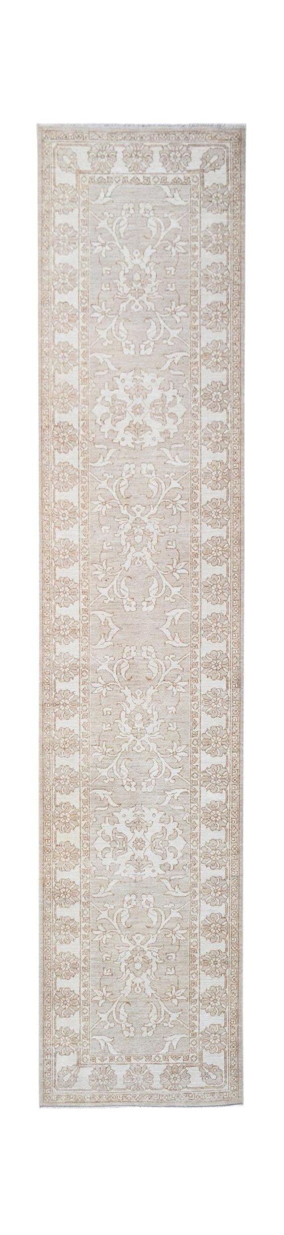 An Afghan Chobi runner rug featuring a traditional floral pattern in soft beige and cream tones.