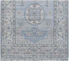 An Afghan Chobi runner featuring a traditional blue and beige geometric pattern with fringe.