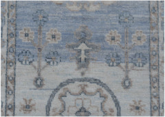 A handmade Afghan Chobi runner featuring traditional floral motifs in soft blue and beige tones.