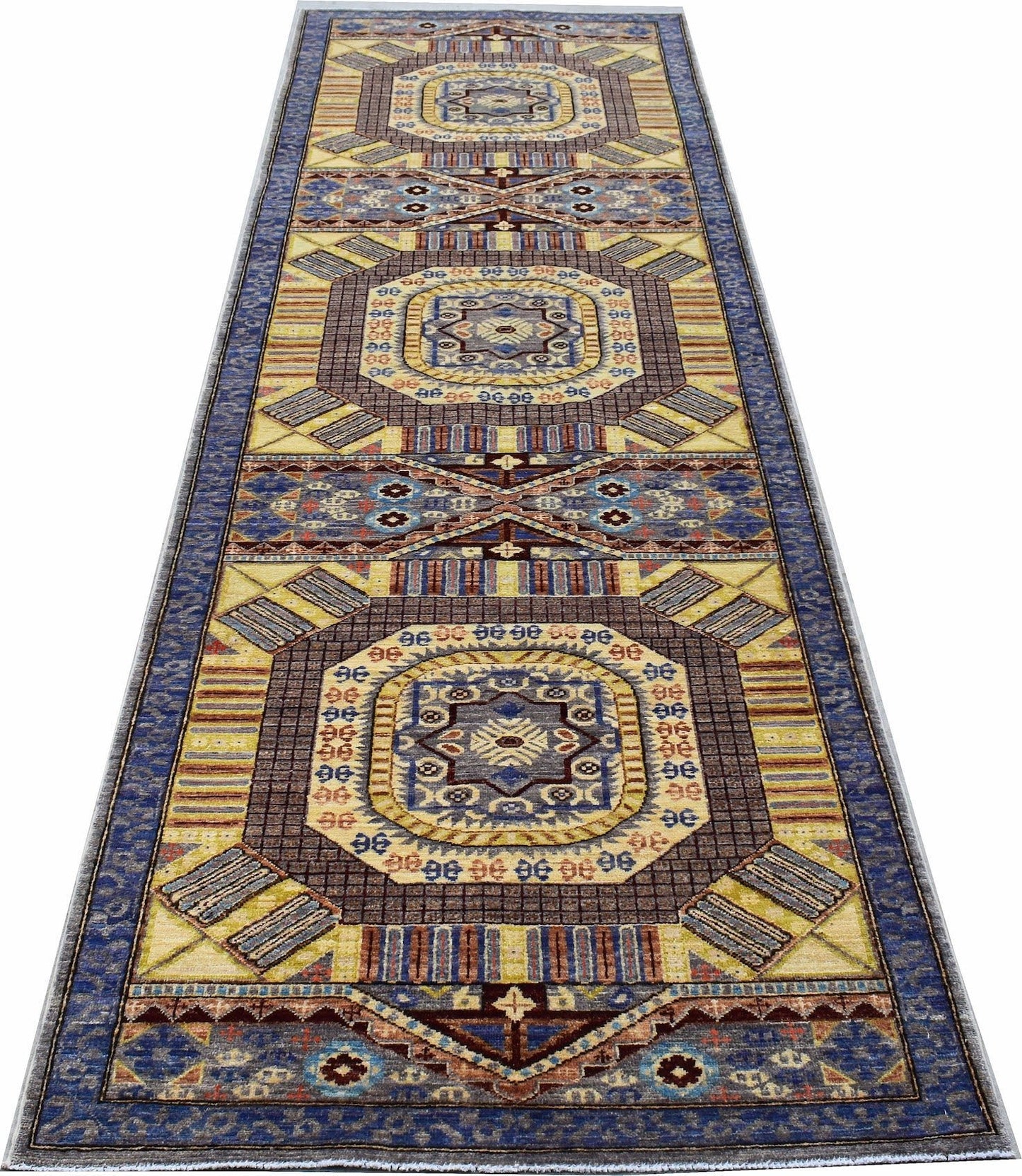 A handmade Afghan Chobi runner rug featuring geometric patterns in blue, yellow, and brown tones.