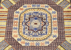A handmade Afghan Chobi runner featuring a central geometric medallion in blue and earthy tones.