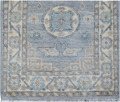 Handmade Afghan Chobi runner featuring a blue field with geometric motifs and a fringed edge.