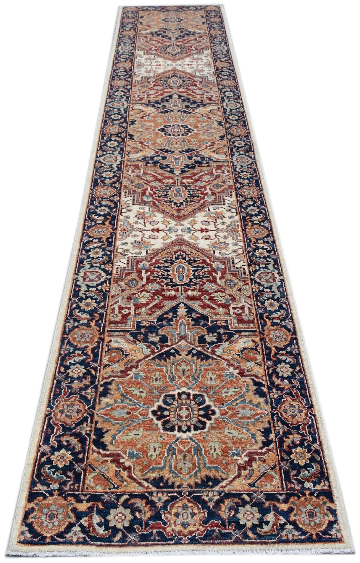 A handmade Afghan Chobi runner rug featuring a traditional floral pattern in rust and blue tones.
