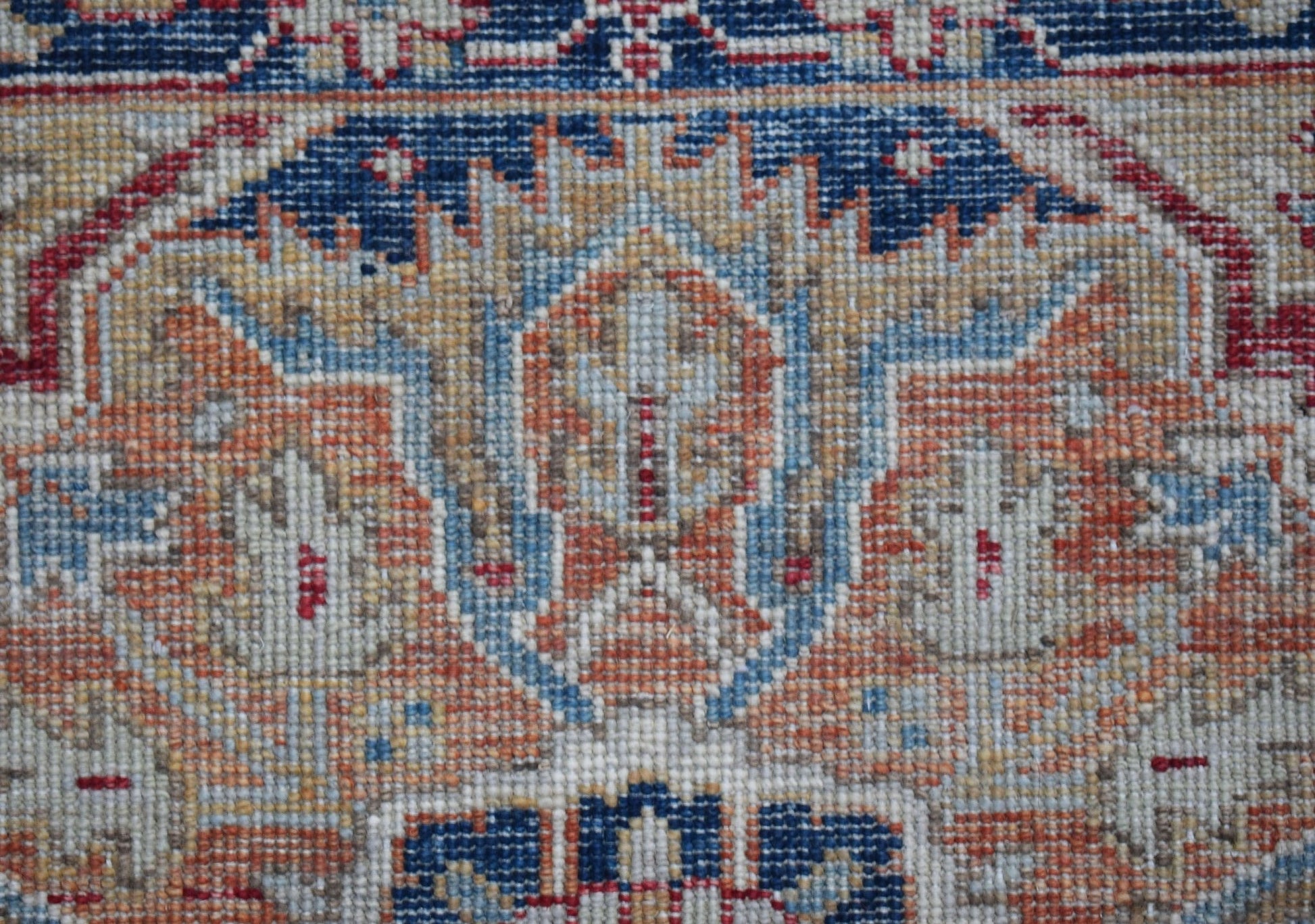 A close-up of a handwoven Afghan Chobi runner featuring intricate floral patterns in earthy tones.