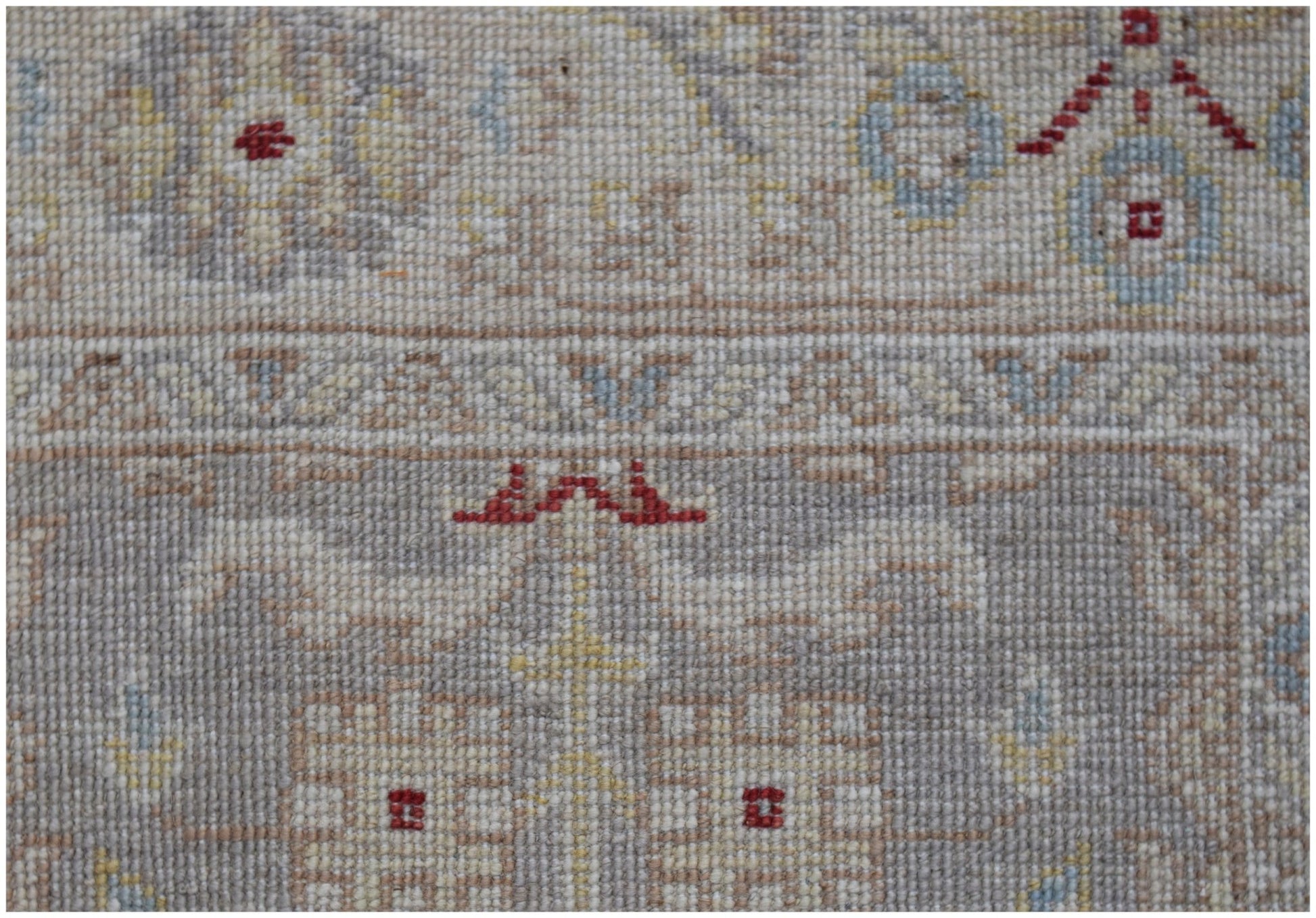 A close-up of an Afghan Chobi runner featuring intricate traditional patterns in muted earth tones.