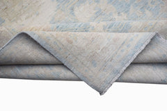 A handwoven Afghan Chobi runner featuring a traditional pattern in soft blue and beige tones.
