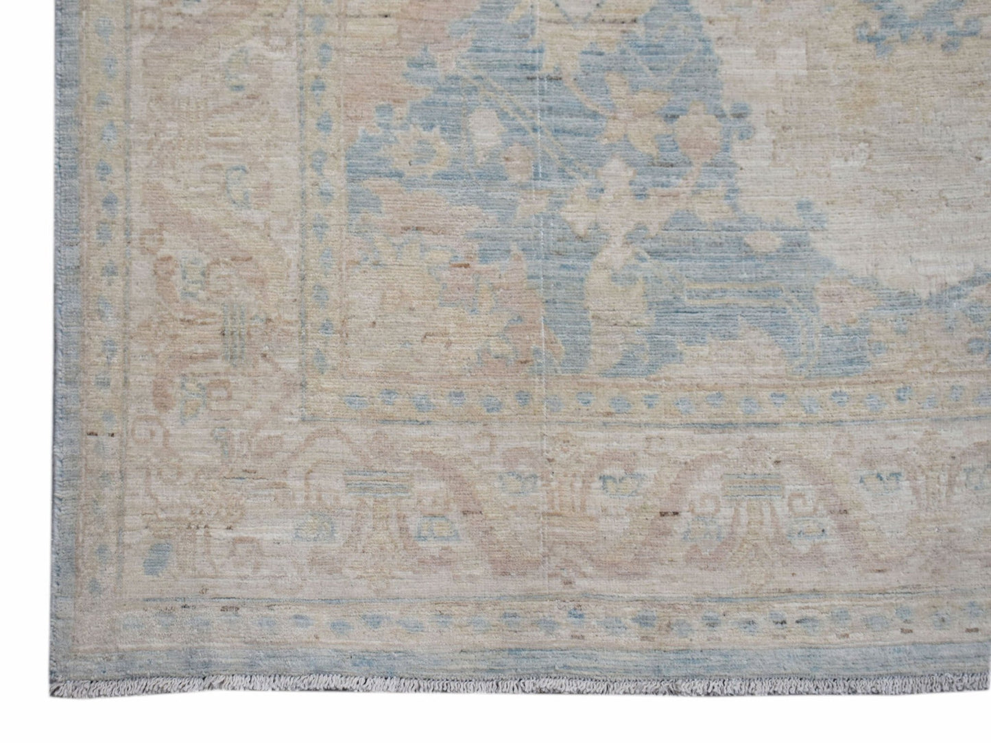 Handwoven Afghan Chobi runner featuring a traditional floral pattern in soft blue and beige tones.