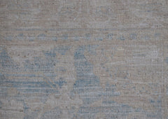 A handwoven Afghan Chobi runner featuring a subtle, distressed pattern in soft blue and beige.