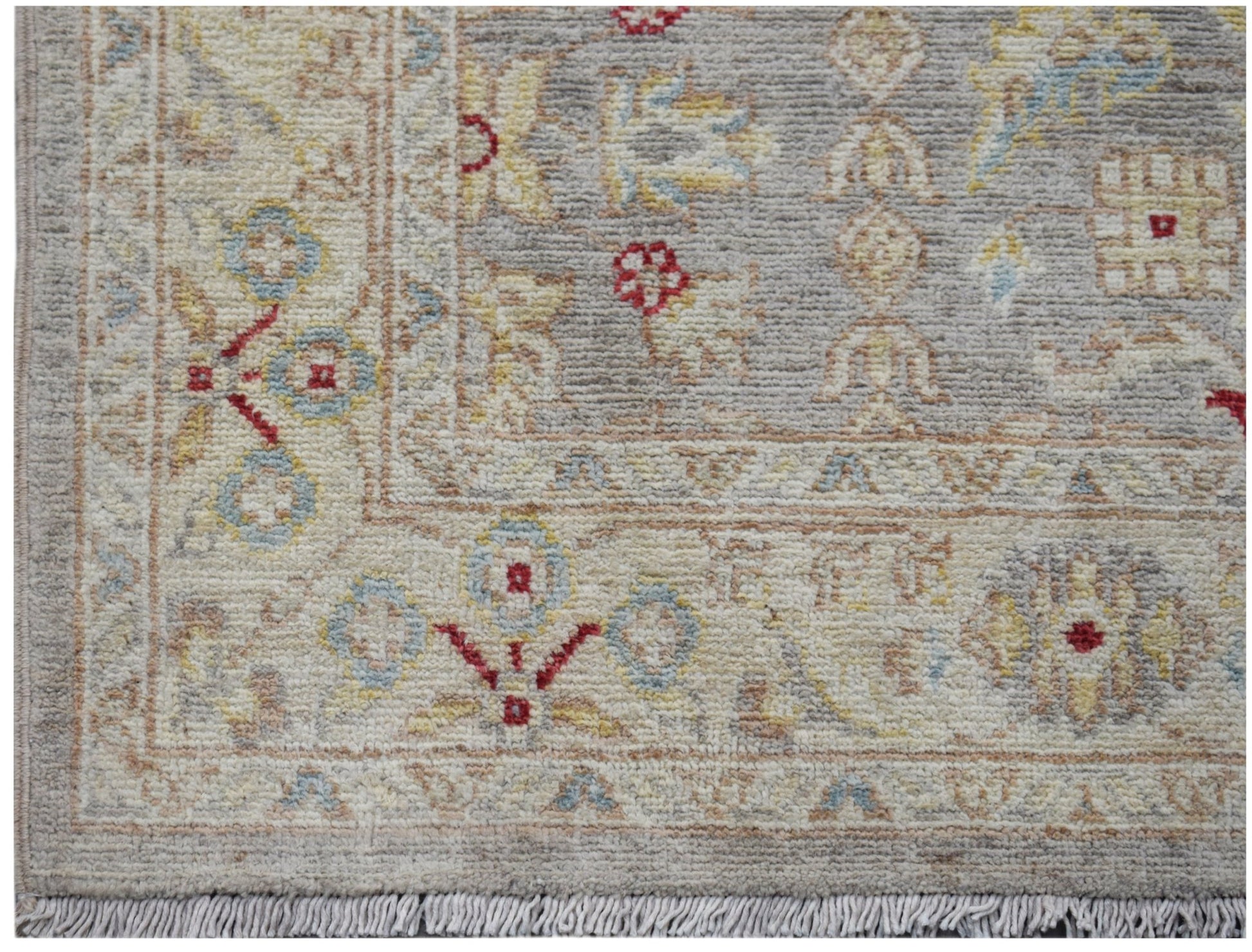 A handmade Afghan Chobi runner featuring a traditional floral pattern in soft, earthy tones.