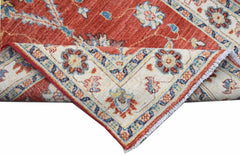A handwoven Afghan Chobi runner featuring a traditional floral pattern in red and cream tones.