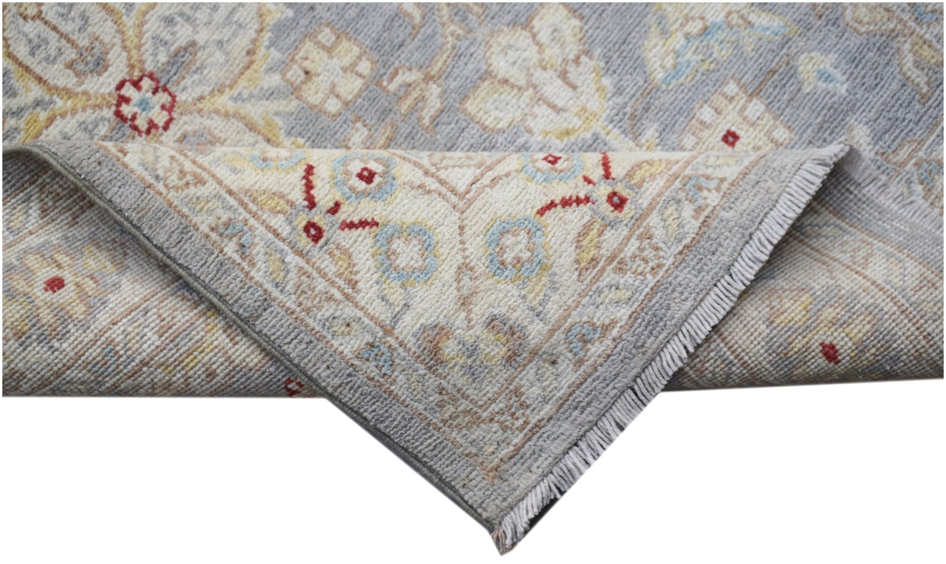 A handmade Afghan Chobi runner featuring a traditional floral pattern in soft blue and cream tones.