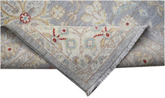 A handmade Afghan Chobi runner featuring a traditional floral pattern in soft blue and cream tones.
