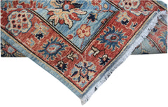 A handmade Afghan Chobi runner featuring a traditional floral pattern in blue and red tones.