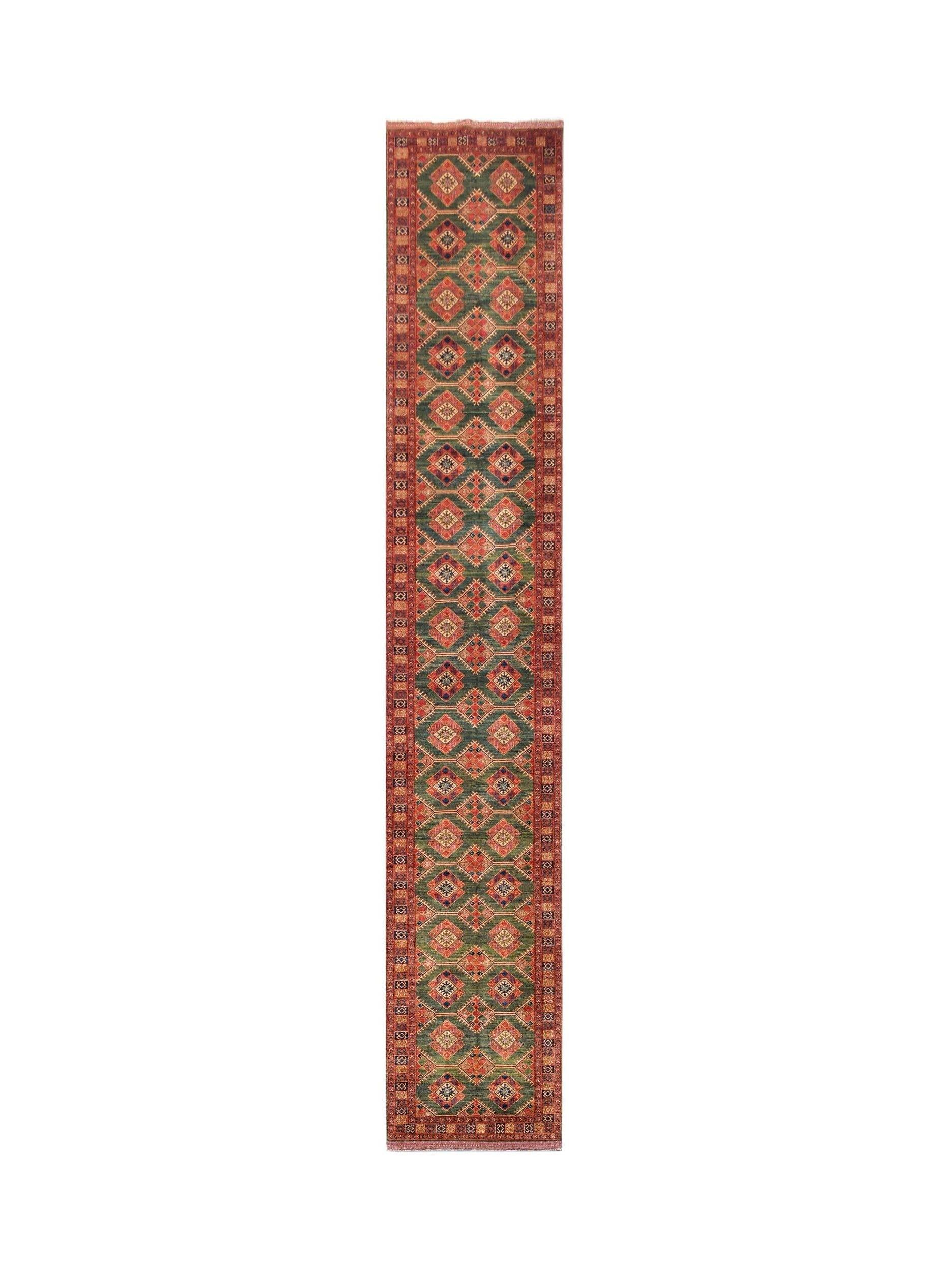 A long, handwoven Afghan Chobi runner rug featuring a repeating diamond pattern in green and red.